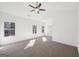 Large bedroom with three windows, a ceiling fan, and soft neutral carpeting at 3279 Greenhill Dr, Villa Rica, GA 30180
