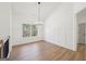Bright dining room with hardwood floors, paneled walls, and view of backyard at 3279 Greenhill Dr, Villa Rica, GA 30180