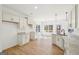 Bright kitchen with granite countertops, white cabinets, and hardwood flooring at 3279 Greenhill Dr, Villa Rica, GA 30180