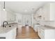 Open-concept kitchen featuring granite countertops, white cabinets, and stainless steel sink at 3279 Greenhill Dr, Villa Rica, GA 30180