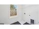 Clean laundry room with modern appliances hookups, dark tile floor and natural light at 3279 Greenhill Dr, Villa Rica, GA 30180