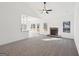 Open living room with a stone fireplace, large windows, and stylish carpeting at 3279 Greenhill Dr, Villa Rica, GA 30180