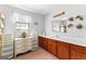 Bathroom featuring a vanity, mirror, drawers and window with natural light at 75 Antioch Rd, Mcdonough, GA 30252