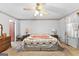 Spacious bedroom featuring a ceiling fan, and soft natural light from large windows at 75 Antioch Rd, Mcdonough, GA 30252