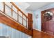 Entryway featuring hardwood floors, a wooden staircase and a front door with seasonal decor at 75 Antioch Rd, Mcdonough, GA 30252