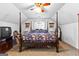 Cozy main bedroom featuring a four-poster bed and ceiling fan at 75 Antioch Rd, Mcdonough, GA 30252