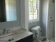 Bathroom featuring a toilet, vanity, and shower at 3683 Brown Dr, Decatur, GA 30034