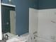 Bathroom with blue accent wall with tub and sink at 3683 Brown Dr, Decatur, GA 30034