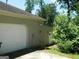Attached two-car garage with a white door and adjacent entrance at 3683 Brown Dr, Decatur, GA 30034