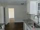Kitchen with granite countertops, stainless steel sink, and white cabinets at 3683 Brown Dr, Decatur, GA 30034