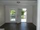 Living room featuring door to deck, fresh paint and wood laminate floors at 3683 Brown Dr, Decatur, GA 30034