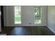 Neutral living room with dark laminate floors and freshly painted walls at 3683 Brown Dr, Decatur, GA 30034
