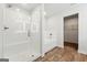 Bright bathroom featuring a glass enclosed shower, tub, and wood look floors at 768 Great Oak Place # 26, Villa Rica, GA 30180