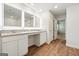 Modern bathroom with dual sinks, granite countertops, wood-look floors, and large, illuminated mirrors at 768 Great Oak Place # 26, Villa Rica, GA 30180