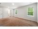 Spacious bedroom featuring neutral walls, carpet flooring, and bright windows, adjacent to the bathroom at 768 Great Oak Place # 26, Villa Rica, GA 30180
