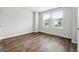 Bright bedroom featuring wood-look flooring, two windows, and neutral paint at 768 Great Oak Place # 26, Villa Rica, GA 30180