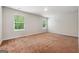 Spacious bedroom featuring neutral walls, carpet flooring, and bright windows with verdant outdoor views at 768 Great Oak Place # 26, Villa Rica, GA 30180