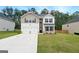 Traditional two-story home showcasing a manicured lawn, two-car garage, and brick and siding accents at 768 Great Oak Place # 26, Villa Rica, GA 30180