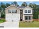 Charming two-story home features a two-car garage, neutral siding, and a well-manicured lawn at 768 Great Oak Place # 26, Villa Rica, GA 30180
