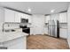 Bright kitchen featuring stainless steel appliances, granite countertops, and white cabinets at 768 Great Oak Place # 26, Villa Rica, GA 30180