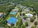 Aerial view of community amenities including tennis courts, pickleball courts, playground, swimming pool, and clubhouse at 169 Wallnut Hall Cir, Woodstock, GA 30189
