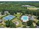 Aerial view showcasing community pool, tennis courts, playground, and landscaping at 169 Wallnut Hall Cir, Woodstock, GA 30189