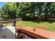 Spacious backyard featuring a well-maintained lawn, wooden fence, and a patio dining set for outdoor enjoyment at 169 Wallnut Hall Cir, Woodstock, GA 30189