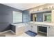 Bathroom featuring blue walls, a built-in tub, and a vanity with ample counter space at 169 Wallnut Hall Cir, Woodstock, GA 30189