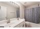 Bathroom featuring a double vanity, large mirror, and a shower-tub combo at 169 Wallnut Hall Cir, Woodstock, GA 30189