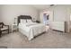 Bright bedroom featuring a gray headboard, white bedding, and an en-suite bathroom at 169 Wallnut Hall Cir, Woodstock, GA 30189