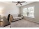 Bedroom with a desk, beige sofa, and large window providing natural light at 169 Wallnut Hall Cir, Woodstock, GA 30189