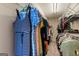 Walk-in closet filled with colorful clothing neatly arranged on shelves and hangers at 169 Wallnut Hall Cir, Woodstock, GA 30189