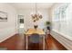 Dining room with hardwood floors, chandelier lighting, and a view into the backyard at 169 Wallnut Hall Cir, Woodstock, GA 30189