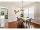 Dining room featuring a chandelier, hardwood floors, and charming wall decor at 169 Wallnut Hall Cir, Woodstock, GA 30189