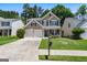 Attractive two-story home featuring a two-car garage, well-maintained lawn, and welcoming front porch at 169 Wallnut Hall Cir, Woodstock, GA 30189