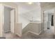Upstairs hallway features neutral colors and entryways into multiple bedrooms at 169 Wallnut Hall Cir, Woodstock, GA 30189