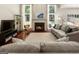 Inviting living room features a fireplace, large windows and comfortable seating area for relaxing at 169 Wallnut Hall Cir, Woodstock, GA 30189