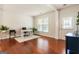 Cozy living room with wood flooring, natural light, and a dedicated workspace at 169 Wallnut Hall Cir, Woodstock, GA 30189