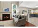 Living room with a fireplace and kitchen view, showcasing an open-concept layout at 169 Wallnut Hall Cir, Woodstock, GA 30189