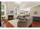 Bright living room features a cozy fireplace, vaulted ceiling, and seamless flow to the kitchen at 169 Wallnut Hall Cir, Woodstock, GA 30189