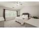 Serene primary bedroom with neutral color palette and large window at 169 Wallnut Hall Cir, Woodstock, GA 30189