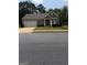 Charming single-story home featuring a brick facade, attached garage, and well-maintained front lawn at 170 Forray Dr, Covington, GA 30016