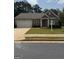 Charming single-story home featuring a brick facade, attached garage, and well-maintained front lawn at 170 Forray Dr, Covington, GA 30016