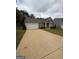 Inviting single-level home with a spacious driveway and manicured landscaping at 170 Forray Dr, Covington, GA 30016