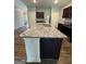 Kitchen island featuring granite countertops and plenty of room for seating and food preparation at 170 Forray Dr, Covington, GA 30016