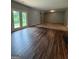 Spacious living area featuring hardwood floors and natural light from the glass patio doors at 170 Forray Dr, Covington, GA 30016