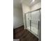 Modern glass shower enclosure with chrome hardware and laminate flooring at 170 Forray Dr, Covington, GA 30016