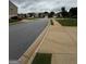 Peaceful neighborhood street view featuring well-kept lawns and sidewalks at 170 Forray Dr, Covington, GA 30016