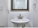 Bathroom featuring a white sink with chrome faucet and a framed mirror at 5640 Terremont Cir, Norcross, GA 30093