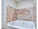 A close-up of the bathtub surrounded by mosaic tile at 5640 Terremont Cir, Norcross, GA 30093